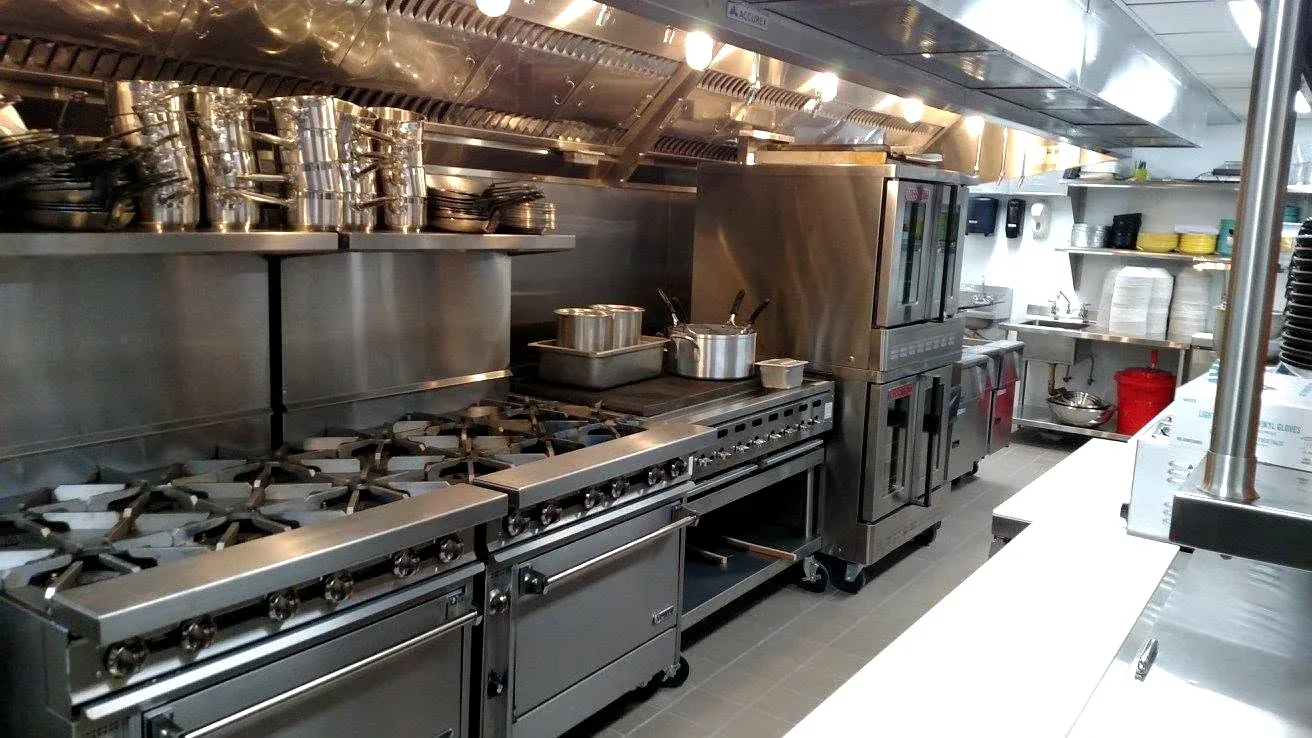 Commercial kitchen with gas ranges and ovens served by Prime Plumbing gas and plumbing work in Greater Boston